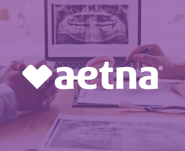 Aetna logo overlaid on dental office setting with patient in treatment chair