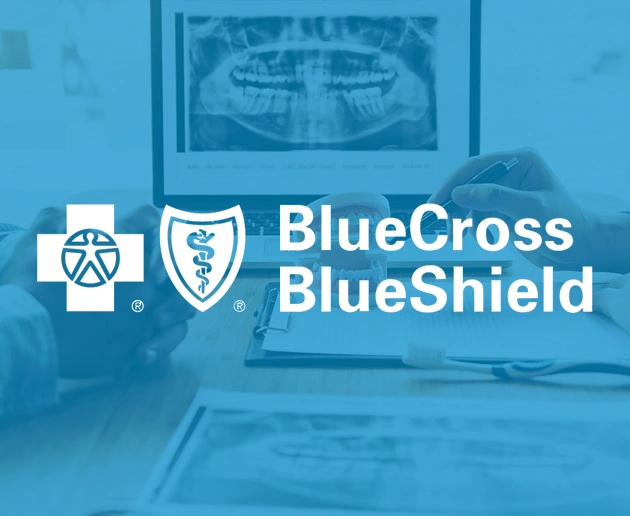 BlueCross BlueShield logo with dental office background showing computer and dental equipment
