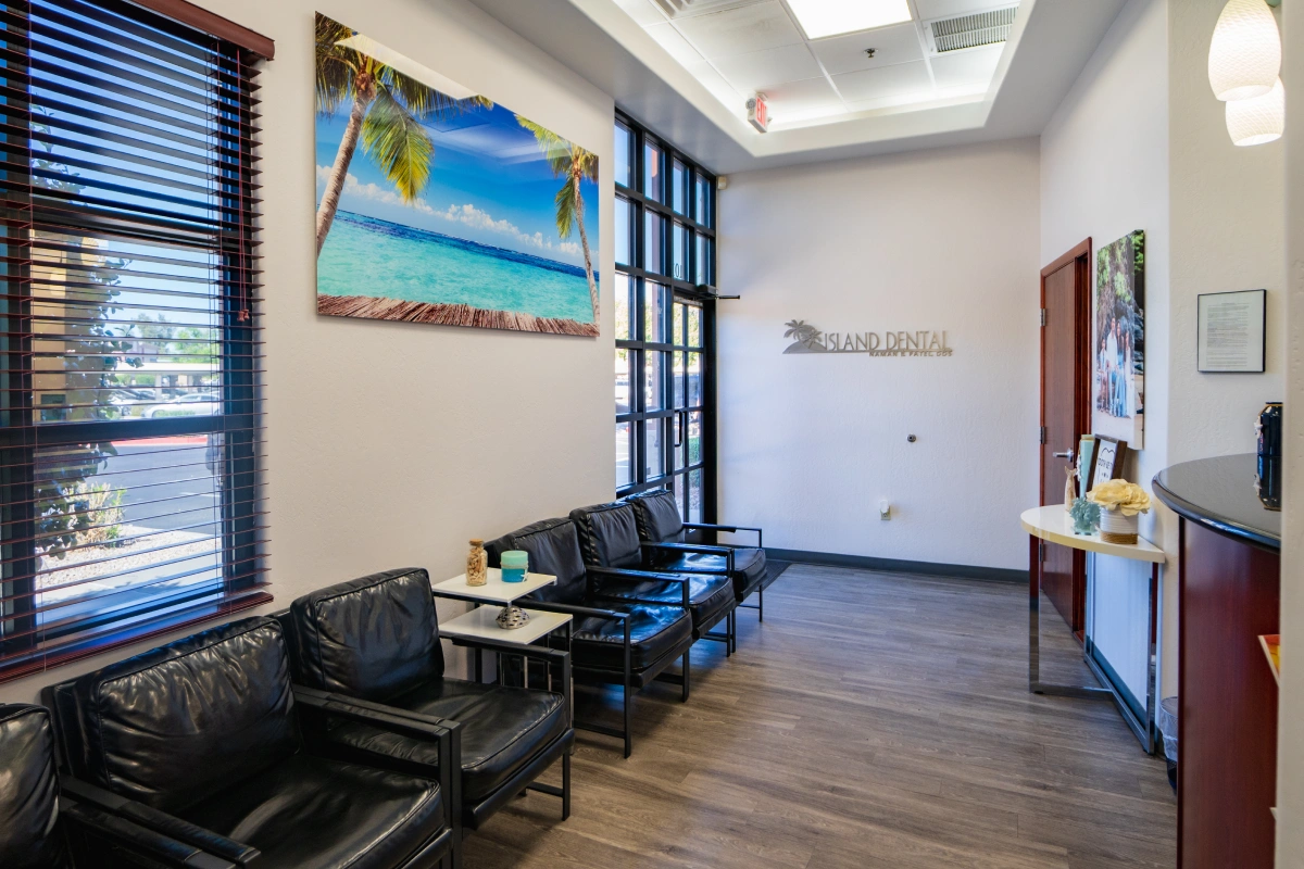 Modern dental office waiting room with comfortable seating, artwork, and professional furnishings.