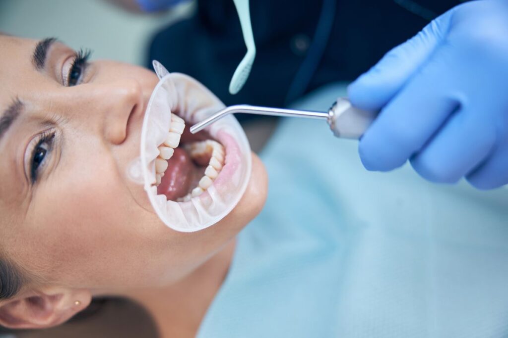 A dentist performs a professional dental examination using specialized tools to provide comprehensive oral care and treatment.