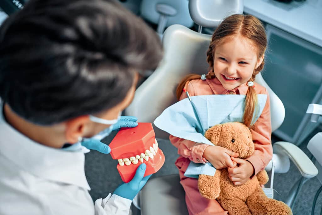 Child learning about dental care during a calm and positive dental visit in Gilbert, AZ